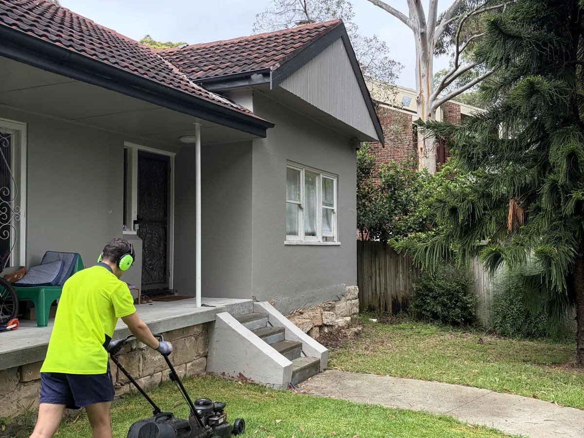 Mowing a front lawn, by Golden Landscaping