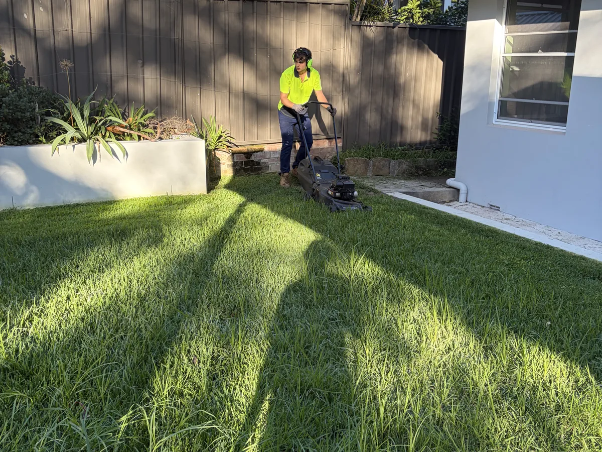 Mowing a long back lawn, by Golden Landscaping